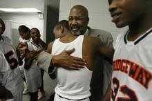 Ridgeway Middle School basketball coach Ted Anderson gets a hug from eighth-grader Sheldon Dawson