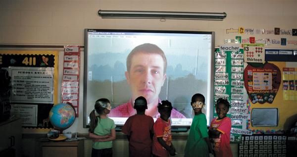Classroom with students watching a screen