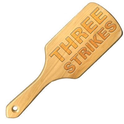 Mocked-up image of wooden paddle inscribed 'Three Strikes'
