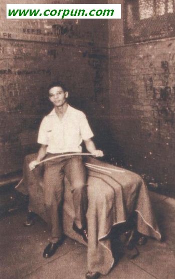 Policeman shows caning equipment