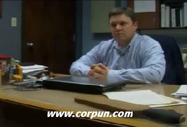School superintendent with paddle on desk